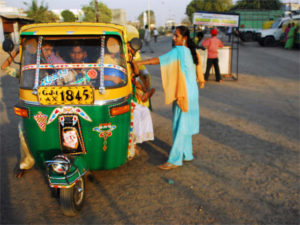 An auto-rickshaw transports passengers in Gujarat, India. Photo by lecercle.