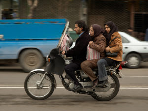 Family on the streets of Tehran. Photo by kamshots.
