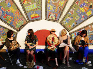 Readers wait at a bus stop