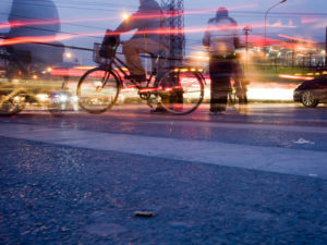 Biker in city night. Photo by Bridget Coila/Flickr