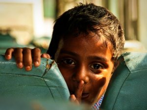 A young boy on a bus in India. Photo by Rob de Wit/Flickr.