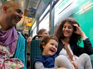 A family travels by train in Germany. Photo by Edo Medicks/Flickr.