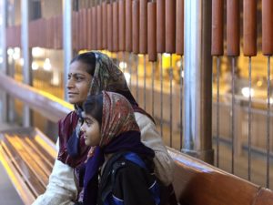 Passengers wait for Ahmedabad, India's bus rapid transit (BRT). Photo by Meena Kadri/Flickr. Cropped.