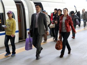 Passengers disembark from a train in Tianjin, China. Photo by Yang Aijun/WorldBank/Flickr. Cropped.