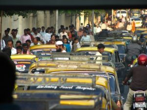 Pedestrians passing across a congested road in Mumbai, India. Photo by Jerry H/Flickr.