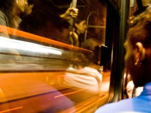 A person looks out the window of a bus in Brazil. Photo by Carolina Pitanga/Flickr.